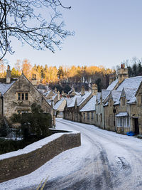 Trees and buildings against clear sky