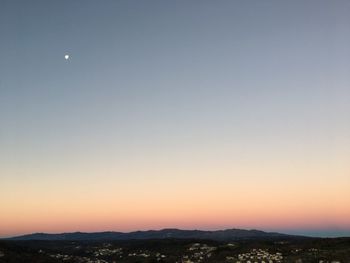 Scenic view of mountains against clear sky at sunset