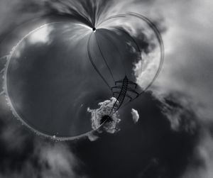 Digital composite image of electricity pylon against sky