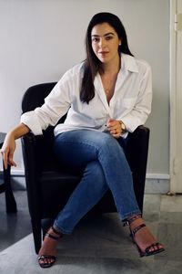 Portrait of young woman sitting on sofa