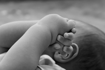 Close-up of baby with hands clasped