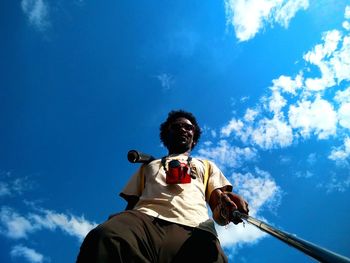 Low angle view of man standing against sky