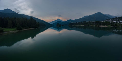 Scenic view of lake and mountains against sky