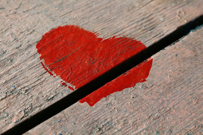 High angle view of red heart shape on wood