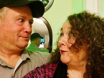 Close-up of young woman with text on wall