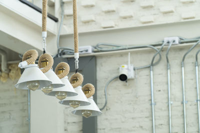 Low angle view of light bulb at ceiling