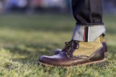 Low section of boy on field