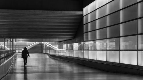 Rear view of woman walking in corridor