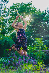 Full length of girl with arms raised