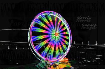 Illuminated ferris wheel at night