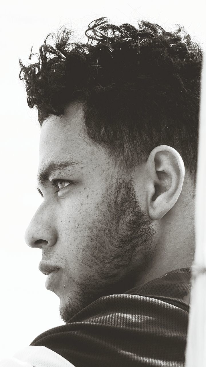 headshot, young adult, lifestyles, young men, person, close-up, human face, contemplation, leisure activity, mid adult, head and shoulders, front view, looking at camera, beard, portrait, serious, mid adult men, clear sky