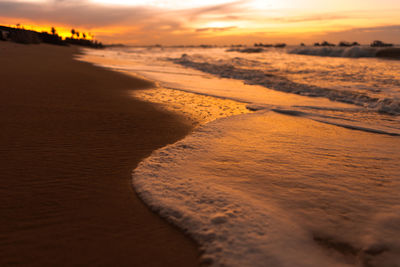 Scenic view of beach against sky during sunset