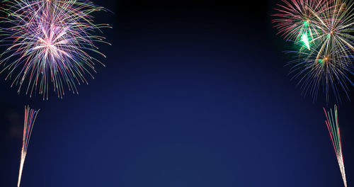 Low angle view of firework display at night