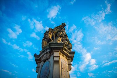 Low angle view of statue against blue sky