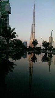 building exterior, architecture, built structure, reflection, water, city, tower, tall - high, skyscraper, waterfront, clear sky, sky, building, lake, tree, river, modern, office building, travel destinations, outdoors