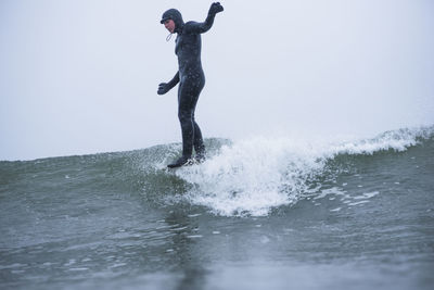 Woman surfing during winter snow