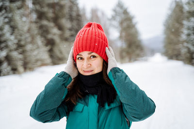 Portrait of smiling young woman in warm clothes