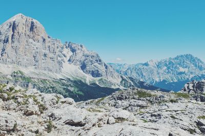 Scenic view of mountains against blue sky