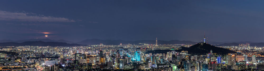 High angle view of city lit up at night