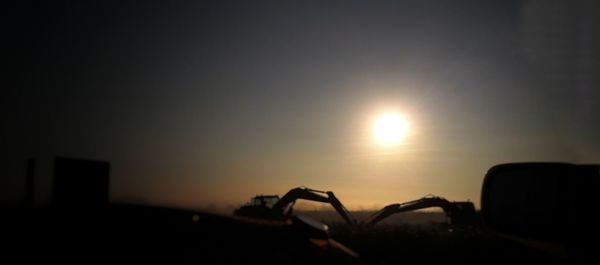 Close-up of car against sky during sunset