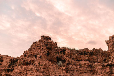 Low angle view of rock formations against sky during sunset
