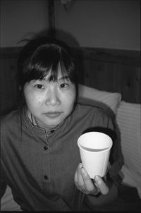 Portrait of woman with coffee cup at home