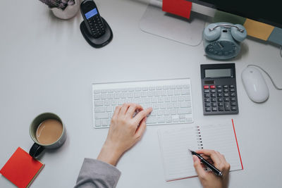 High angle view of man using mobile phone on table