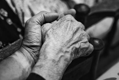 Cropped image of couple holding hands