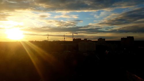 Silhouette buildings against sky during sunset