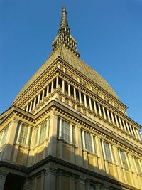 Low angle view of tower against blue sky