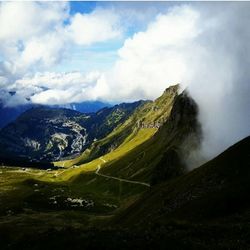 Scenic view of mountains against cloudy sky