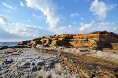 View of rocky shore against the sky