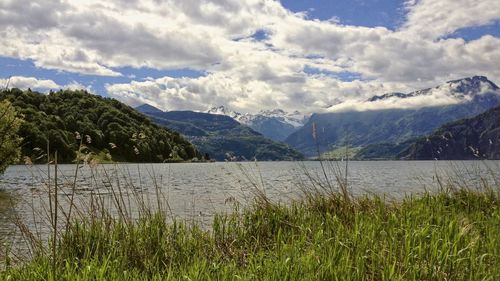 Scenic view of lake and mountains against sky