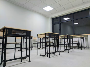 Empty chairs and table in classroom