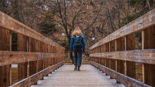 Full length of woman walking on footbridge