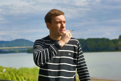 Young man smoking cigarette