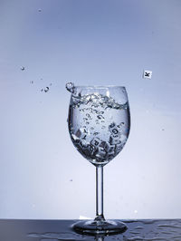 Close-up of wine glass against white background