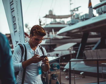 Young man photographing on camera