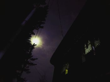 Low angle view of illuminated cables against the sky