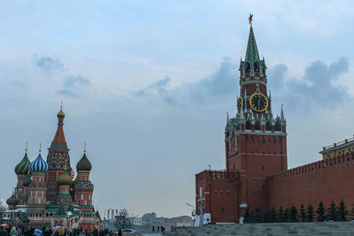 Intercession cathedral and spasskaya kremlin tower with clock and star on red square in moscow.