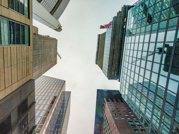 Directly below shot of buildings in city against sky