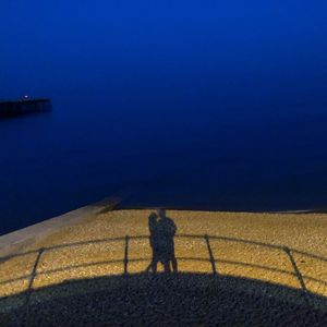 High angle view of two people walking on road