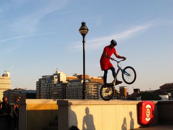 Woman riding bicycle on city street