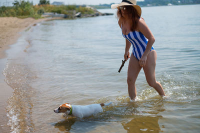 Side view of girl playing in sea