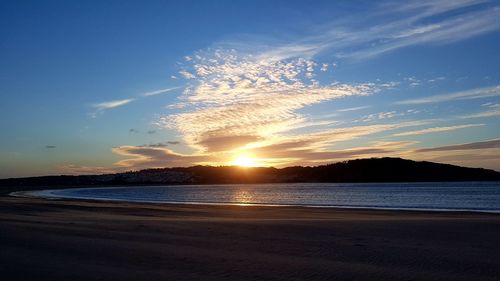 View of beach against cloudy sky