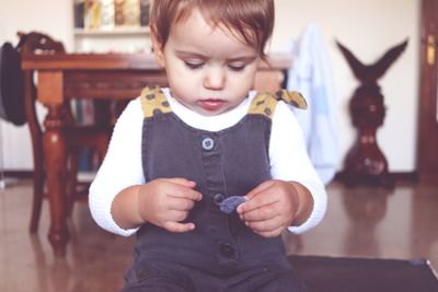 Cute boy looking at camera at home