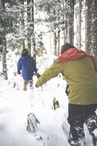 Woman standing on tree trunk