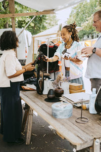 Customer paying through tap to pay method while shopping at flea market