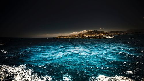 Scenic view of sea against clear blue sky
