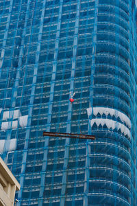 Low angle view of modern glass building in city